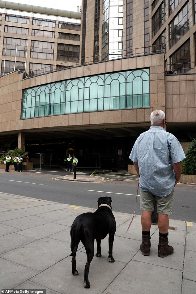 Police officers are monitoring what is going on outside the Britannia Hotel