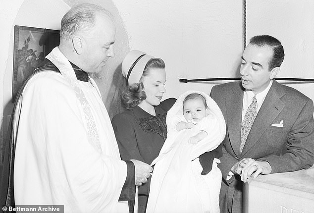 Liza is pictured at her Beverly Hills christening in 1946 with her parents, Judy and Vincente (right), as well as Reverend Herbert J. Smith (left)