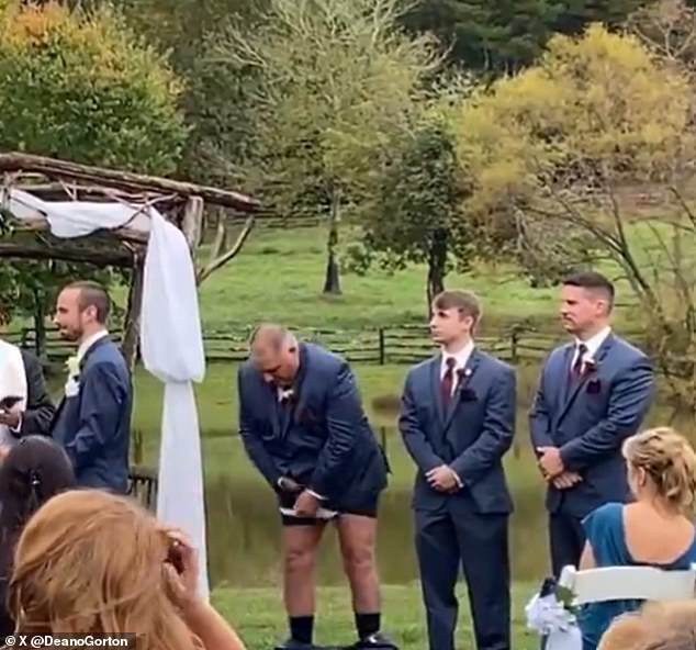 In a viral video captured on X, the heartfelt moment a bride and groom appeared to be sharing their vows was interrupted by a man whose suit bottoms suddenly fell to the floor