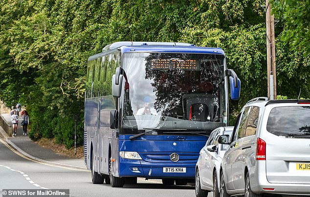 A coach waits for pickup in Bourton-on-the-Water this July - a very popular month for visitors