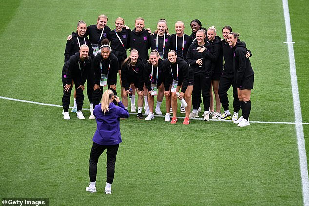 Players of England pose for a photo during a pitch inspection prior to the big game where they will face Spain