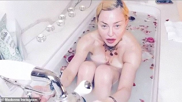Madonna styled her blonde locks into an updo for the video while she also shared a sultry snap of herself staring at the camera, with two large roses covering her chest