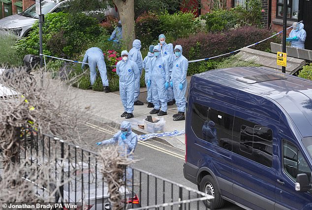 Pictured: Forensics officers at the flat shared by Mr Alfonso and Mr Longworth in Sheperd's Bush, west London, on July 13 last year