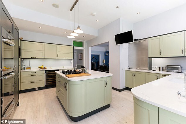The clean and spacious kitchen is also filled with modern fittings and fixtures