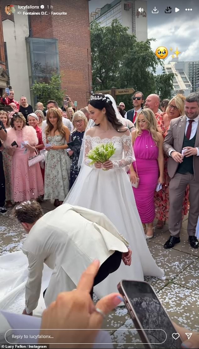 Heading outside to be covered in white confetti, Jack ran out in front of Hanni to pick up the train on her dress and lay it out for photos
