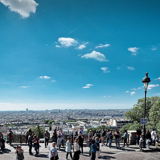 Montmartre offers sweeping views over Paris, where tourists often gather on the steps to look at