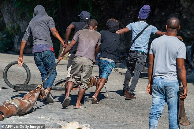 The body of a man is dragged across the street as Haiti contends with a power vacuum now occupied by criminal gangs