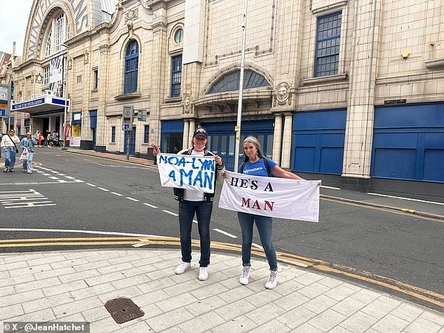 Two of the protestors showed off their banners outside the Winter Gardens on Sunday