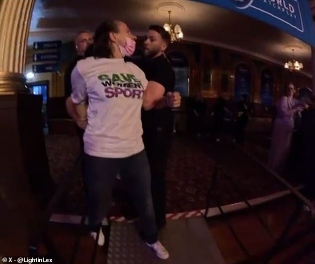 One of the demonstrators was wearing a shirt that read: 'Save women's sport'
