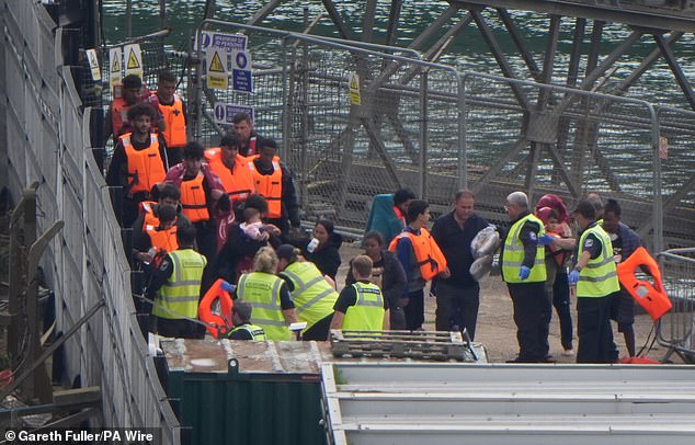 Pictured: A group of people thought to be migrants are brought in to Dover, Kent, from a Border Force vessel after a small boat incident in the Channel on July 27, 2025