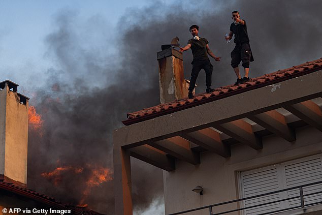 Locals desperately attempt to escape a burning house in Kryoneri, near Athens