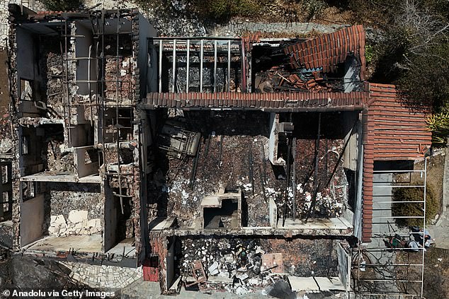 An aerial view shows the extent of the damage to a burnt-down building in the suburban area