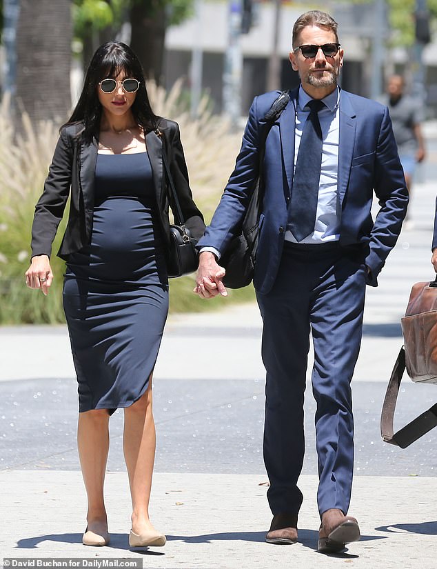 Evans is in the midst of a legal dispute with ex-husband Ioan Gruffudd (pictured outside court with new wife Bianca Wallace) regarding child support payments for their two daughters