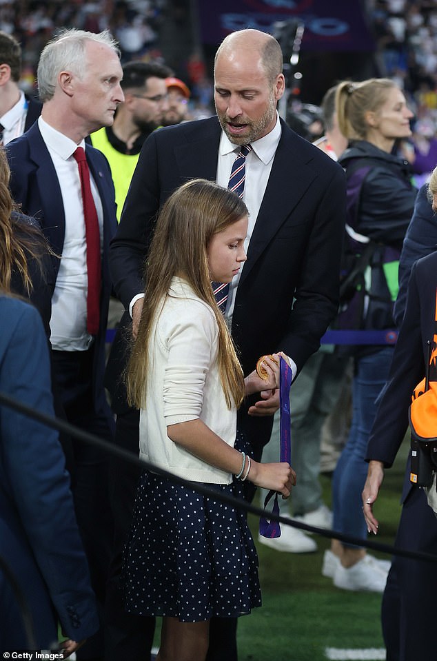 The royal was also given a winners medal to keep after the presentation ceremony - which she was seen holding on to reverently (pictured)