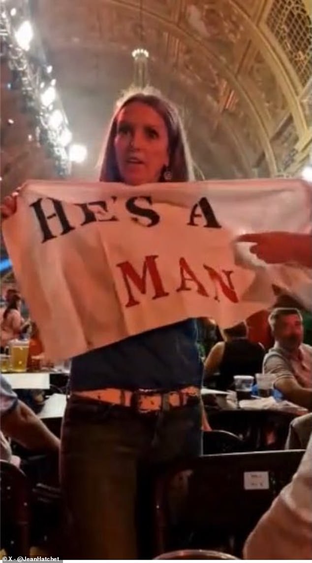 Jean Hatchet held a banner reading: 'He's a man', while another protester wore a a shirt which said: 'Save women's sport.'