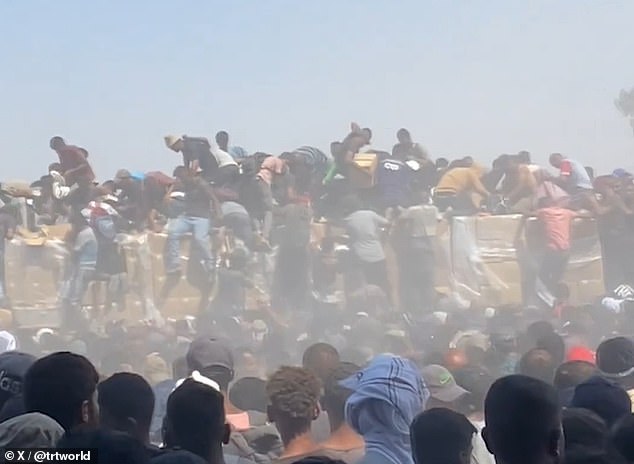 Footage purported to show civilians scrambling to claim aid in Gaza on Sunday, July 27