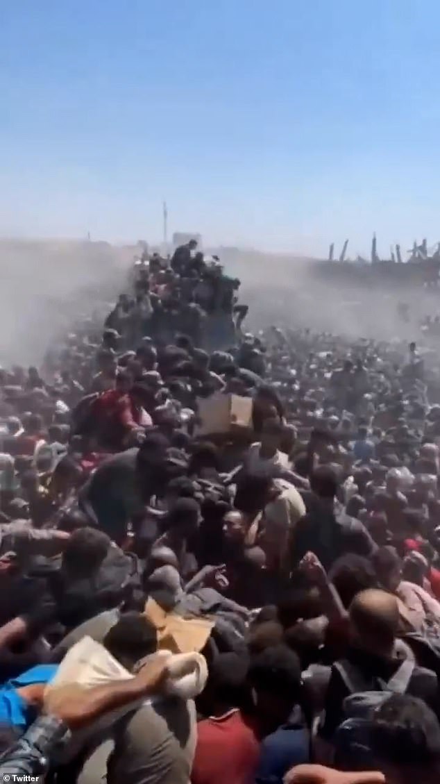 Damaged buildings can be seen in the background of distressing footage of civilians seeking aid in video ostensibly show before the pauses, on Saturday