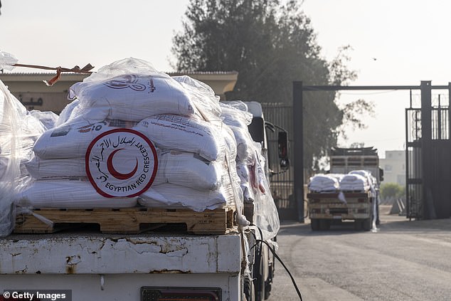 Trucks carrying aid marked with the Red Crescent logo enter Gaza through the Rafah border crossing with Egypt in the south of the Palestinian enclave, on July 28, 2025