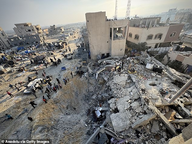 Palestinians inspect the rubble of the destroyed house following an Israeli airstrike on the Mawasi neighborhood, at a home belonging to the Nufel family in western Khan Yunis, July 28