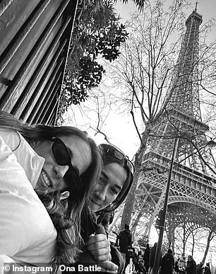 Ona and Lucy took a selfie with the Eiffel Tower in the background