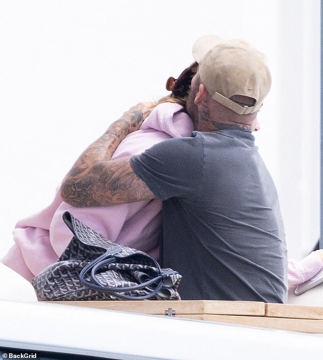 David shared a sweet embrace with his youngest daughter as they departed the luxury vessel to head to the shore together