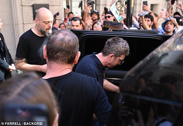 Noel is mobbed by fans as he leaves his Manchester hotel on the way to their sold-out hometown gig