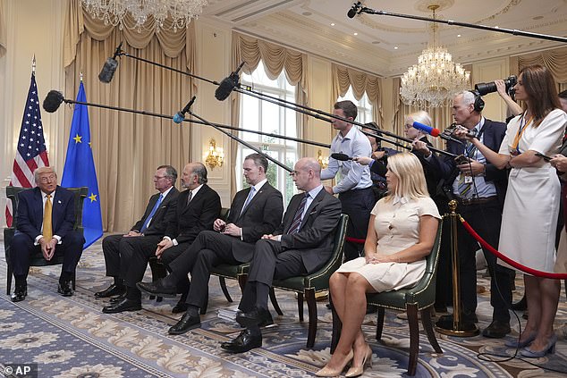 Trump annoucned the deal in a ballroom while aides Karoline Leavitt (r), Steven Miller, Jamieson Greer, and Larry Lutnick, and US ambassador to Britain Warren Stephens watched.