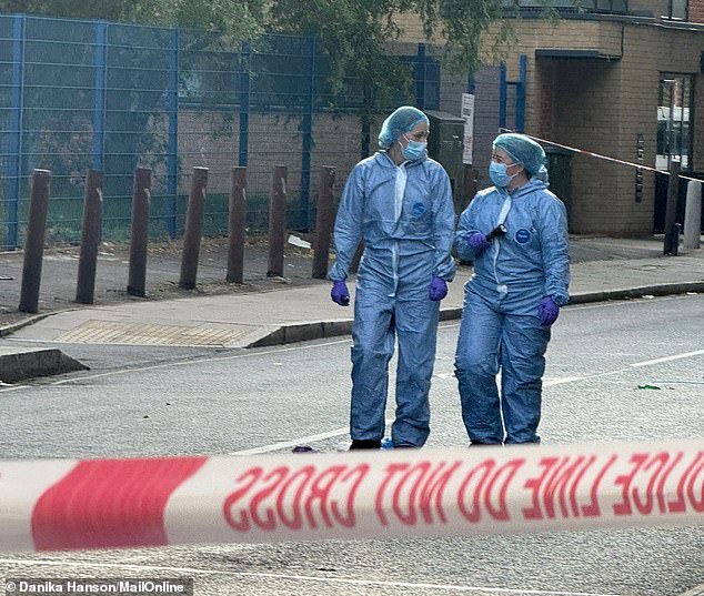 Two men have died after the stabbing which has left a further two men injured - with one in critical condition (Pictured: Forensics on the street)