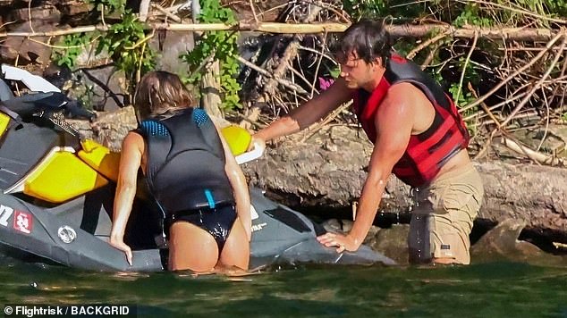 While enjoying her break from her busy acting schedule, she showed off her toned figure in a black, one-piece swimsuit with a low-cut neckline to highlight her ample assets