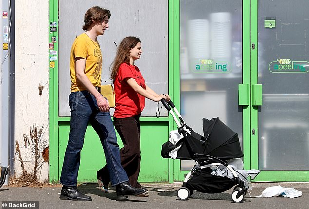Her long-term partner also revealed his unique sense of style as he stepped out in a yellow T-shirt, jeans and boots