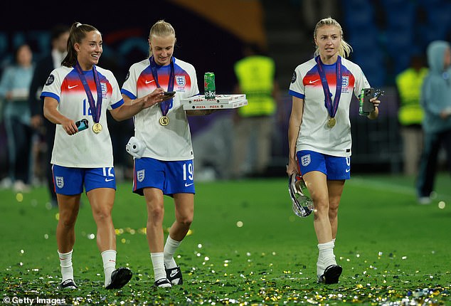 Beever-Jones and Leah Williamson (right) refuelled with pizza and beer after Sunday's big win