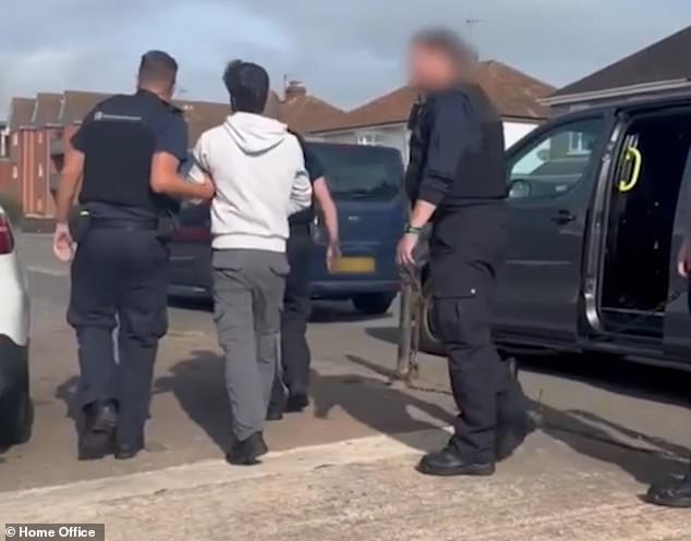 Car wash workers being led away during the raid - one of thousands carried out every year