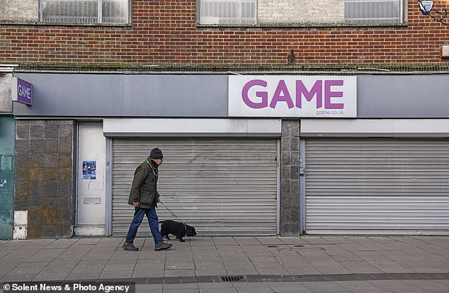 WATERLOOVILLE: A man walks his dog past a closed down Game store on in Waterlooville