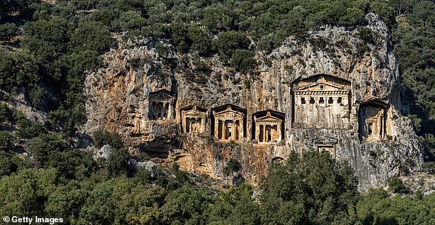 The impressive ruins of the ancient trading city of Kaunos be found across the river from the cliffs, in modern-day Dalyan