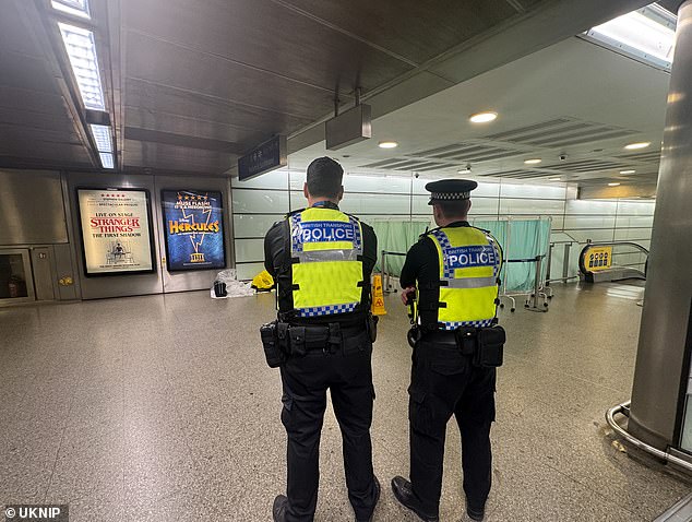 Police at the scene where a man was found lying unconscious inside St Pancras station