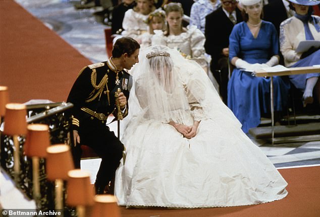 Charles and Diana sit whispering to each other during their wedding ceremony