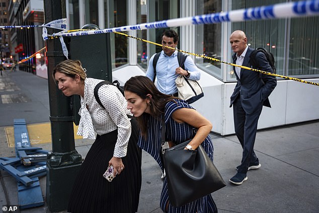 Photos from the scene showed scores of people in business attire frantically leaving with their hands up