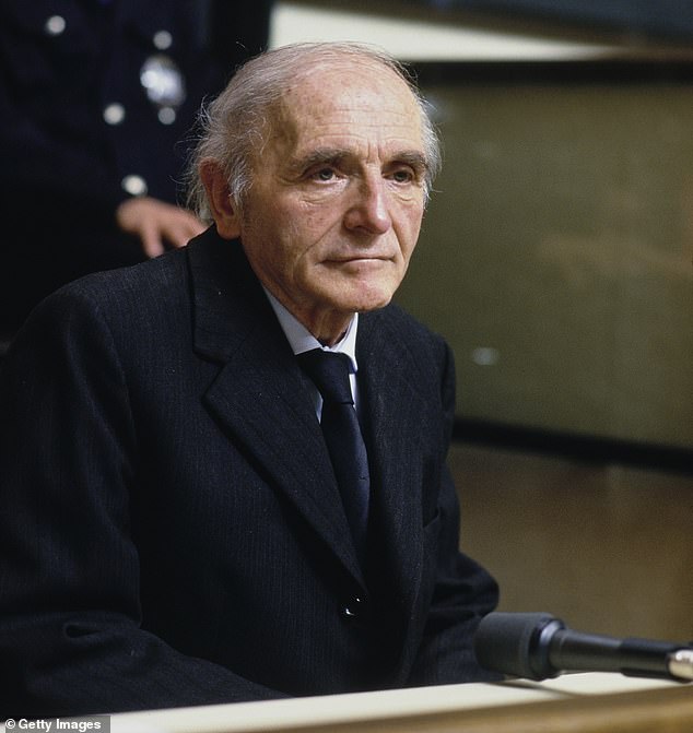 Klaus Barbie sits behind a glass screen at the opening of his trial in Lyons, France, May 11th, 1987