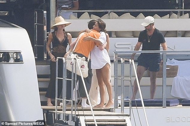 Eva Longoria, 50 - a close family friend of the Beckhams - was also spotted hugging Cruz on their multi-million pound vessel with her husband José Bastón, 57 (R)