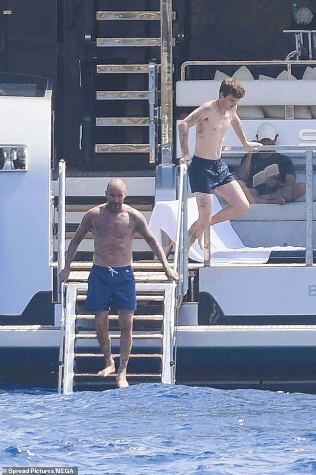 David showed off her muscular physique in navy swimshorts