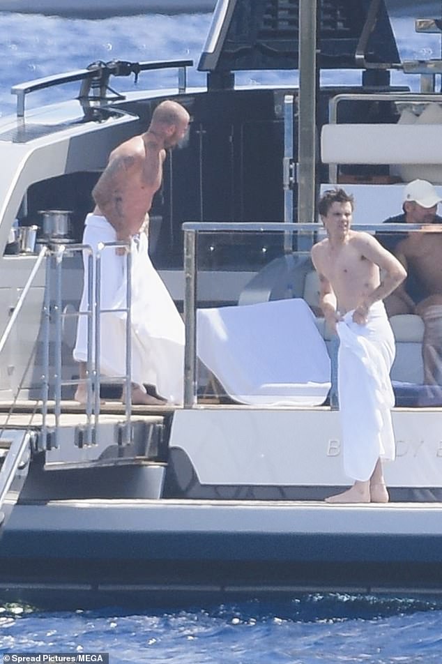 The father-son duo dried off after a fun afternoon in the sea