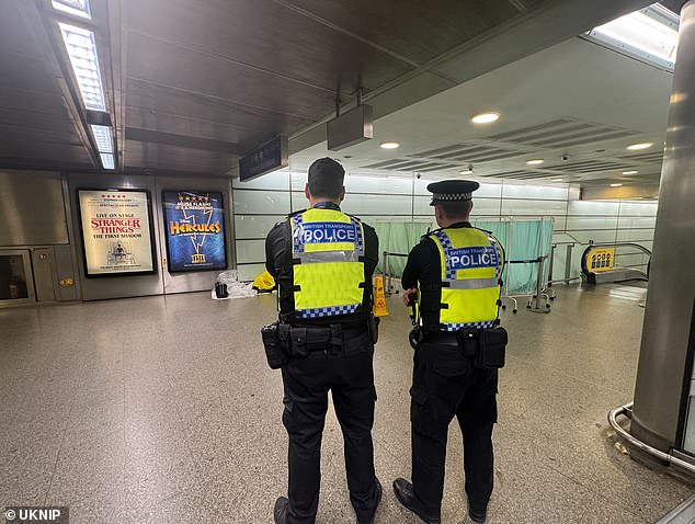 Police at the scene where a man was found lying unconscious inside St Pancras station on Monday evening