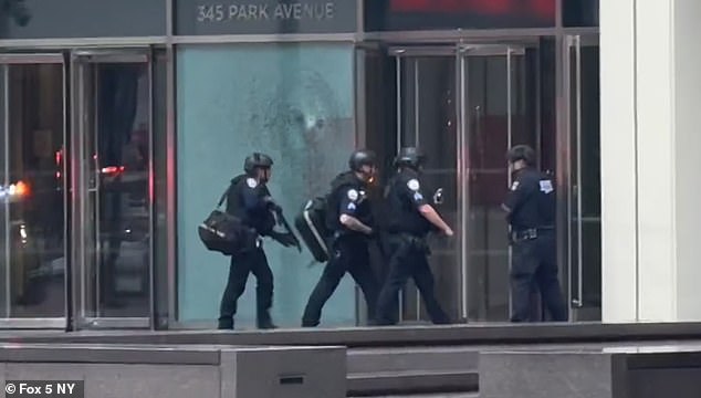 Heavily-armed officers were seen rushing into the skyscraper following the shooting