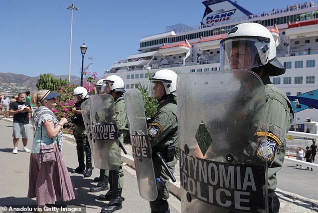 The demonstrators clashed with police squads, armed with riot shields and helmets, who were deployed at the pier where the cruise ship was docked