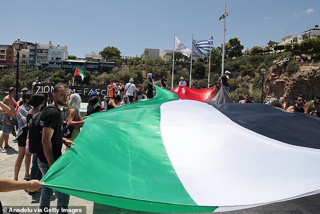Protesters on the southern Greek island of Crete unfurled a huge Palestinian flag at the port of Agios Nikolaos and shouted 'Free, free Palestine'