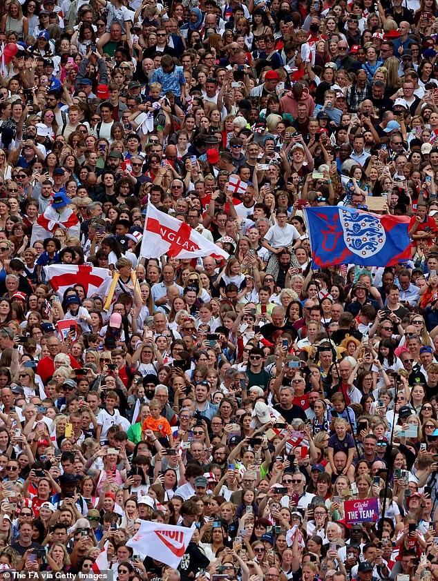 The huge crowd of fans waved flags and held their phones out to try and grab a picture of the England stars