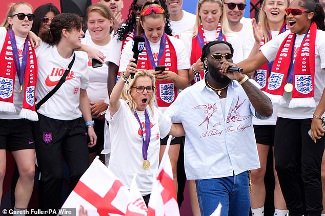 Sarina Wiegman on stage with Burna Boy, who she has described as her 'favourite' music artist