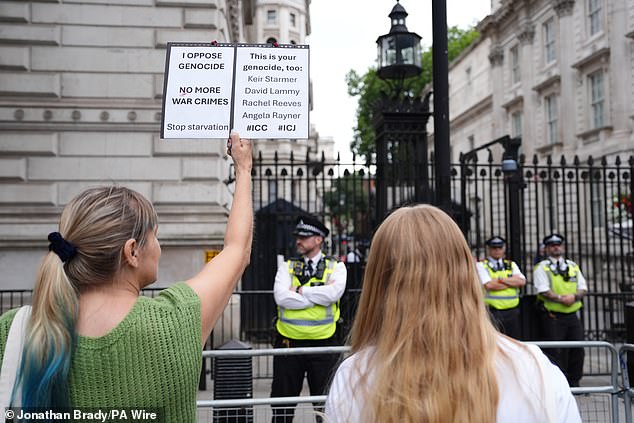 People take part in a pro=-Palestine protest outside Downing Street in London moments before Keir Starmer announced Britain would recognise a Palestinian state