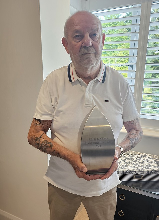 Mr French is pictured with the ashes of his daughter Katie and her beloved rescue dog, Minnie