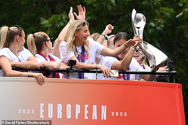 Ecstatic England players atop the bus as it rolled down the Mall with the trophy